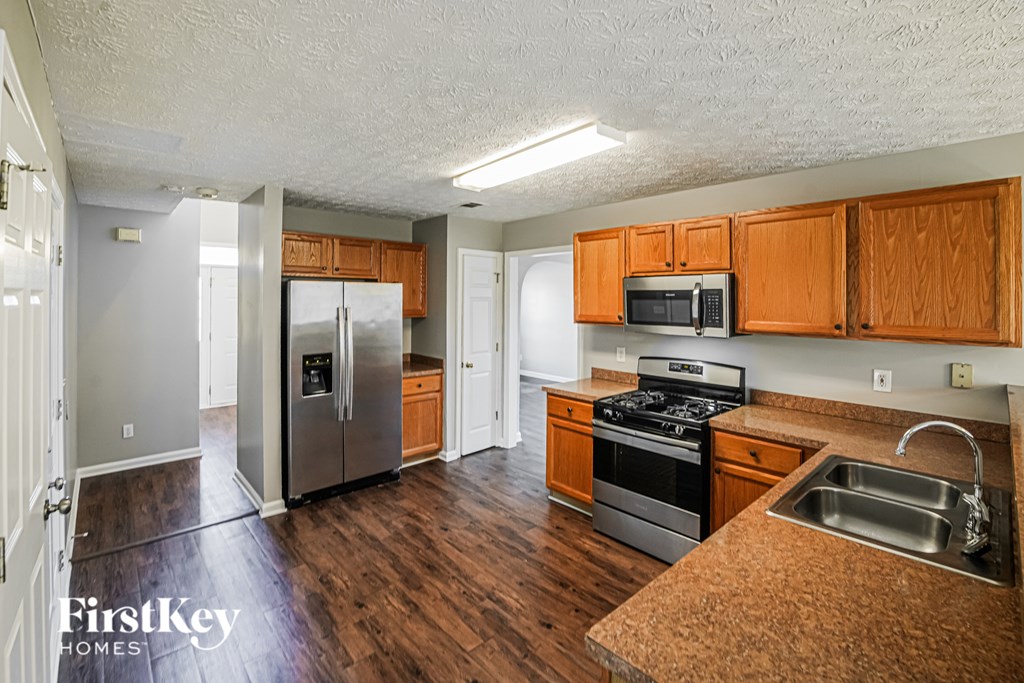 A kitchen with wooden cabinets and stainless steel appliances.