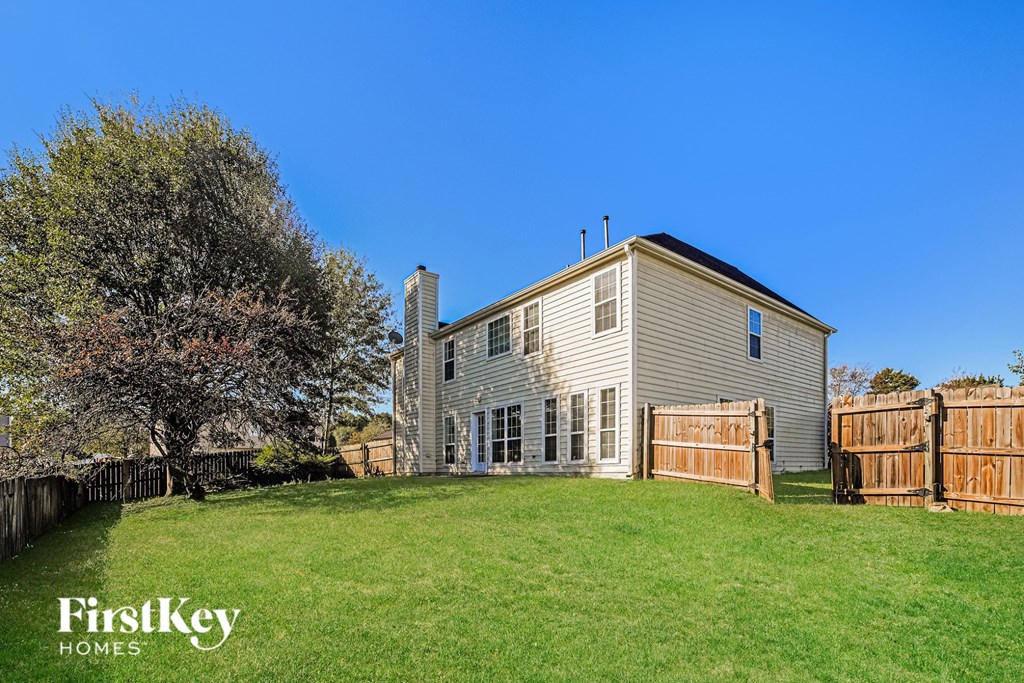A large house with a fence in front of it.