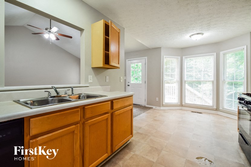 a kitchen with a sink and a stove and a window