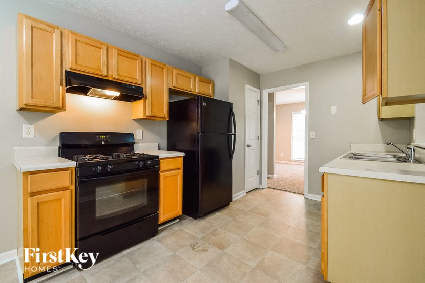 a kitchen with black appliances and wooden cabinets