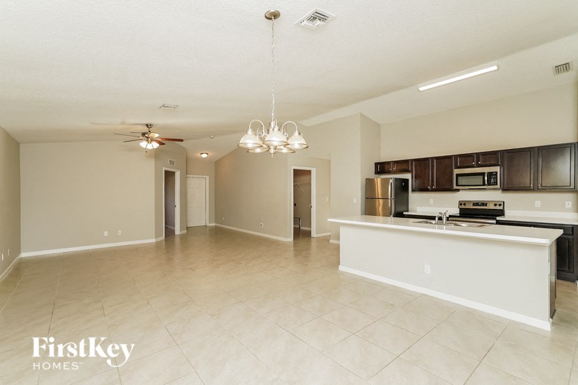 an empty kitchen and living room with a counter top