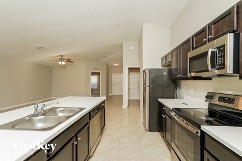 a kitchen with stainless steel appliances and white counter tops