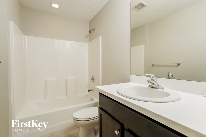a white bathroom with a sink and a toilet