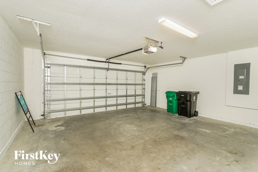 the inside of a garage with white walls and a white garage door
