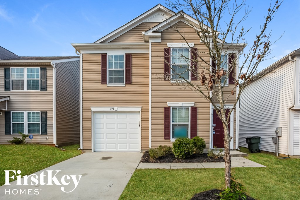 a beige and with a white garage door