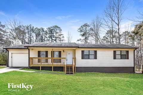 A house with a grey roof and a yellow front porch.