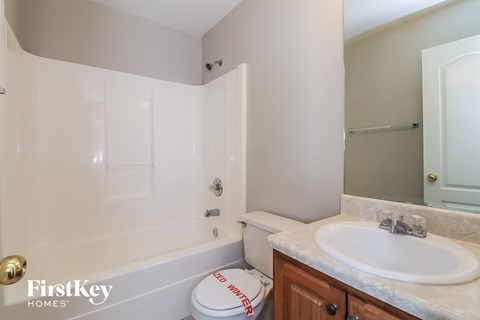 a bathroom with a sink and a toilet and a shower