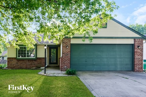 A house with a garage door and a sign that says "FirstKey Homes".