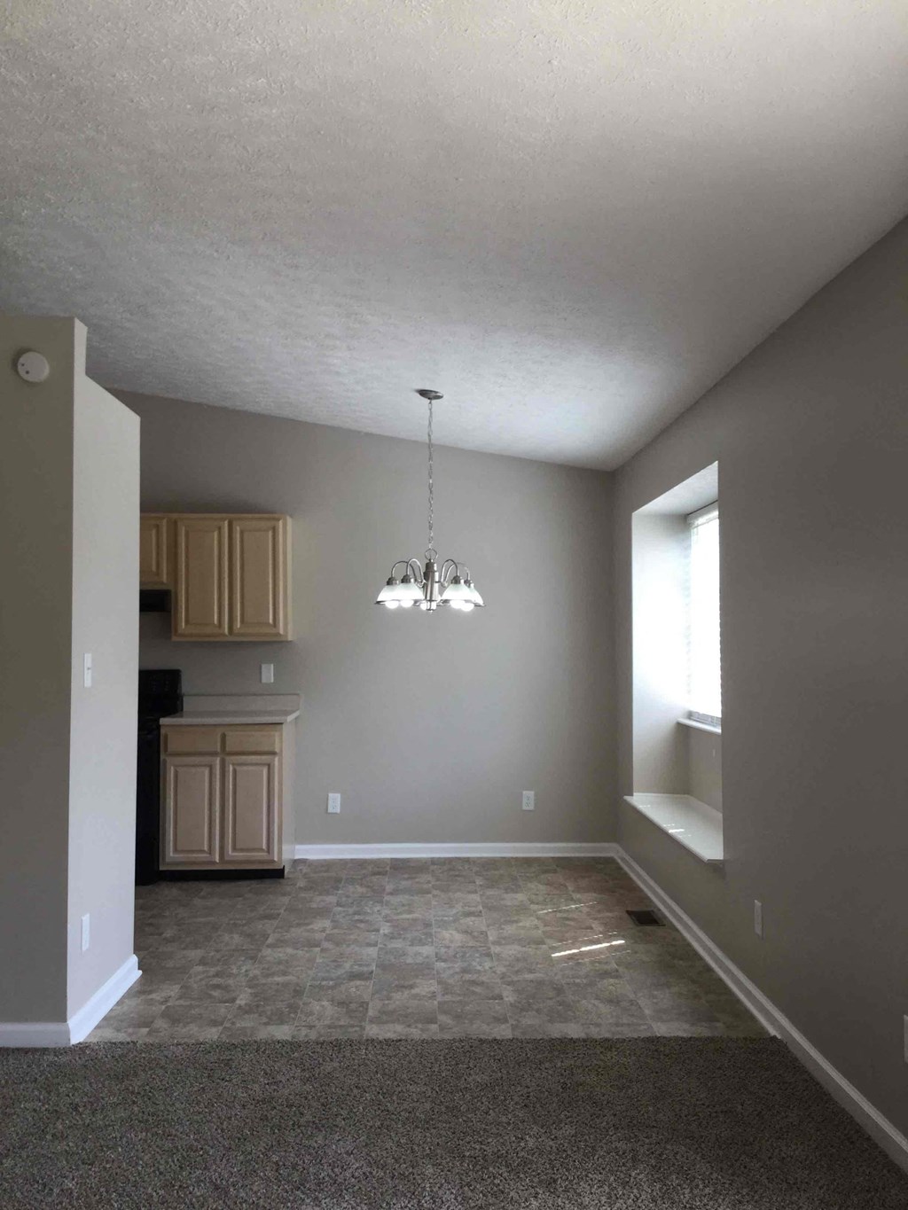 A room with a kitchen area and a window.