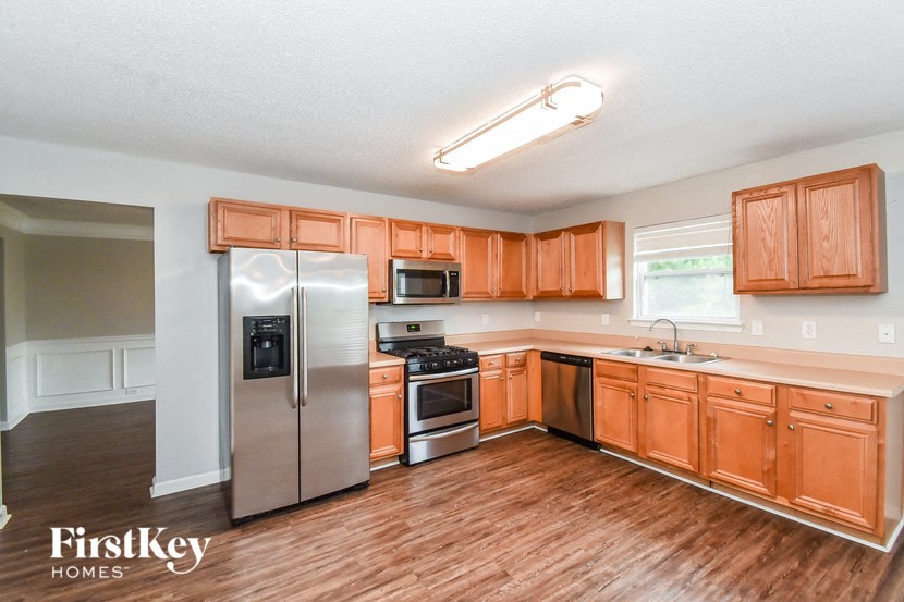 a kitchen with wooden cabinets and stainless steel appliances