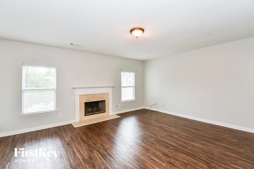 a living room with wood floors and a fireplace