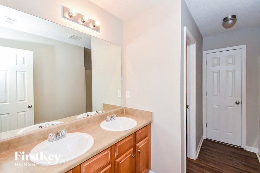 a bathroom with two sinks and a large mirror