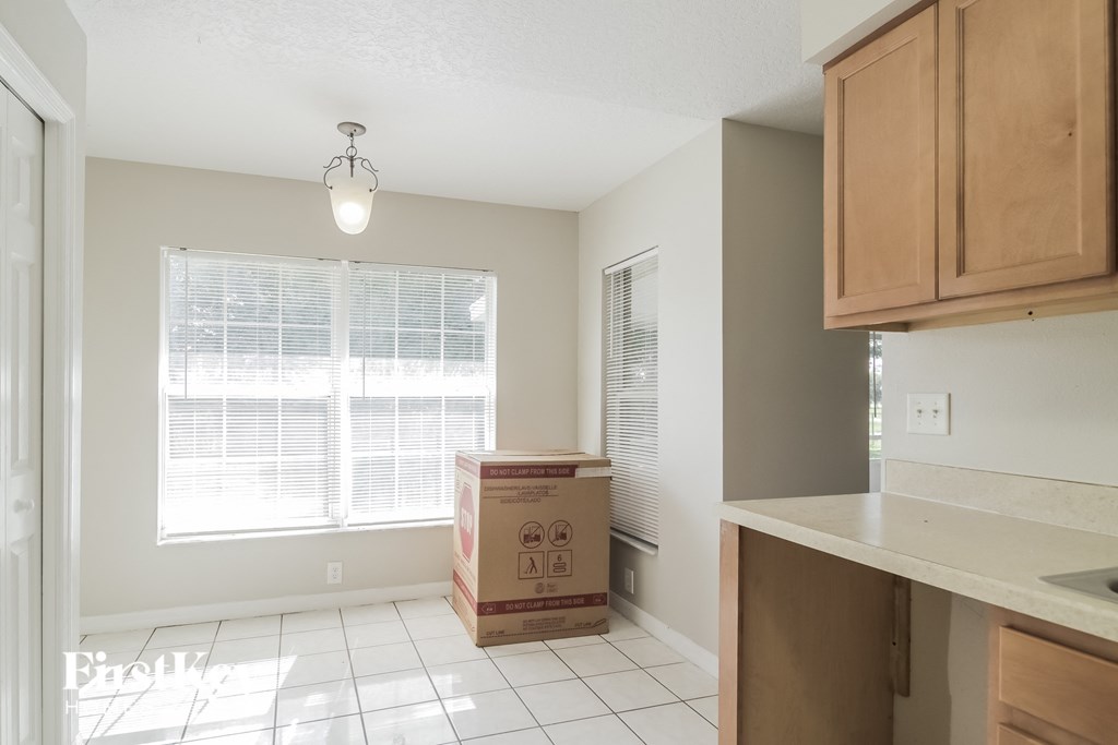 A kitchen with a box on the floor.