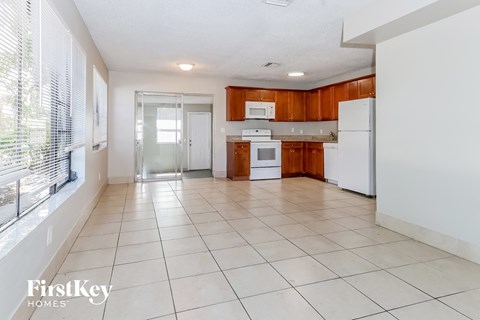 A kitchen with white appliances and wooden cabinets.