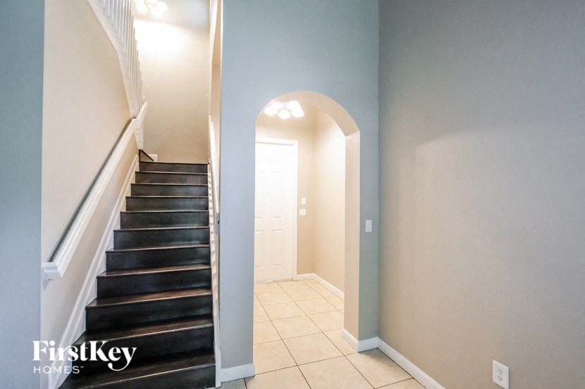 a staircase in a home with blue walls and a white door