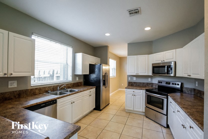 full view of the kitchen with granite countertops and stainless steel appliances