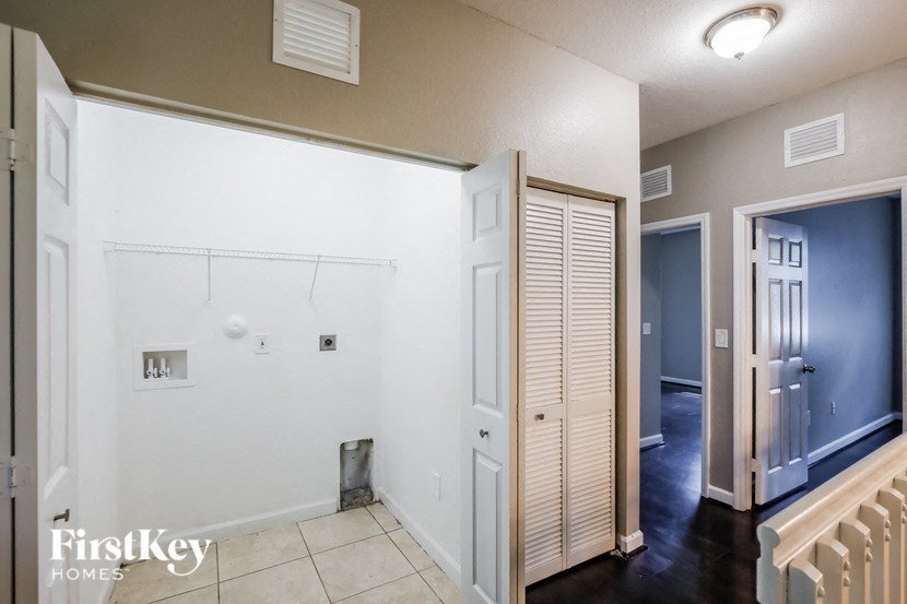 a hallway with a closet and a door to a bathroom