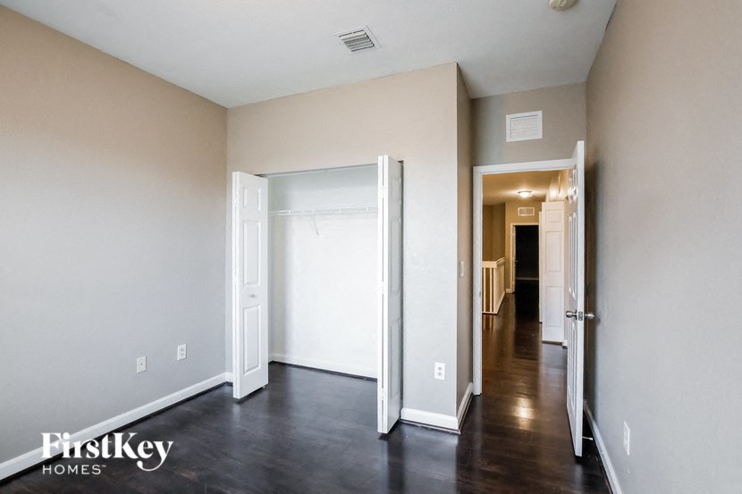a renovated living room with a hallway to a closet and a door to a bedroom
