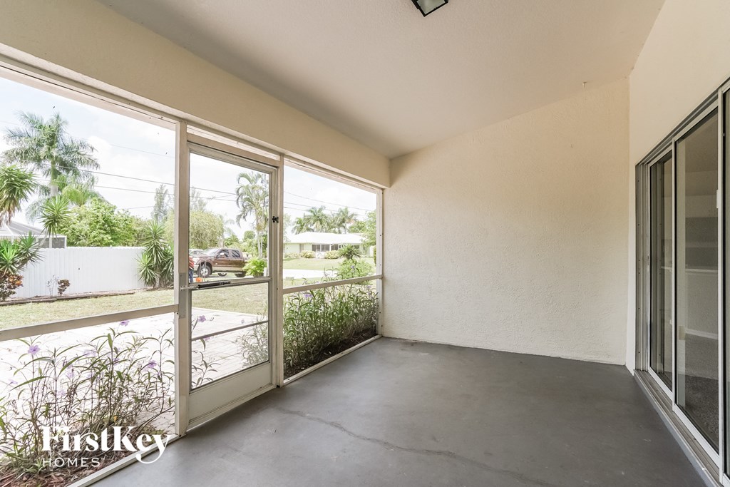 the living room has a balcony overlooking the yard and the street