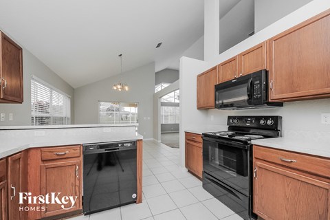 a kitchen with black appliances and wooden cabinets