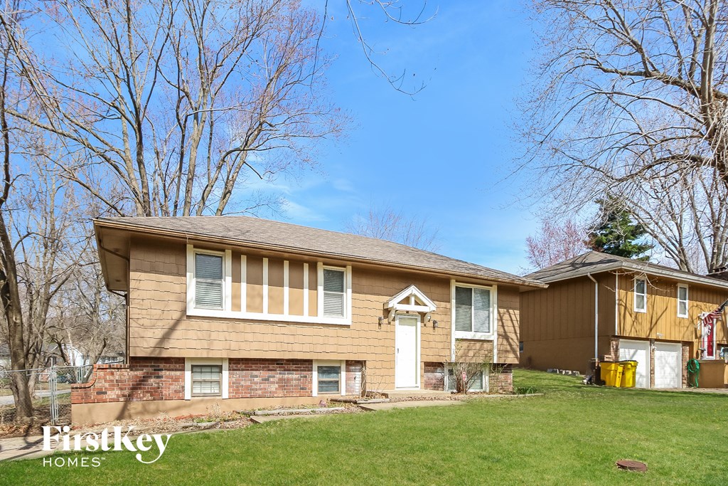 A house with a brown and beige exterior is for sale.
