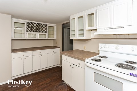 a white kitchen with white appliances and white cabinets