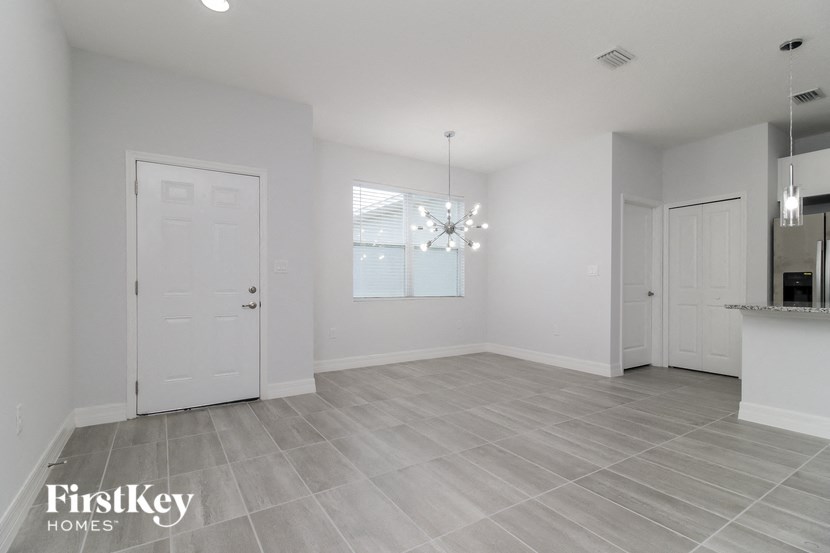 an empty living room with white walls and a white door