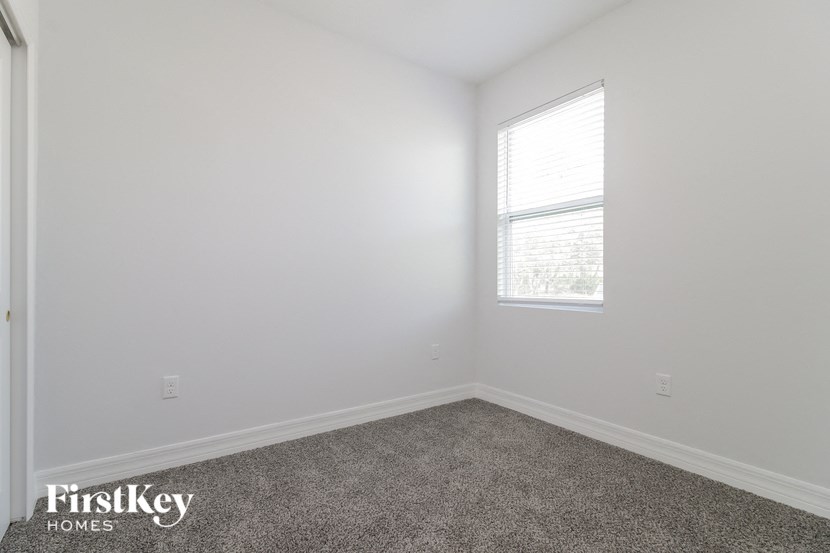 a white room with a window and carpet
