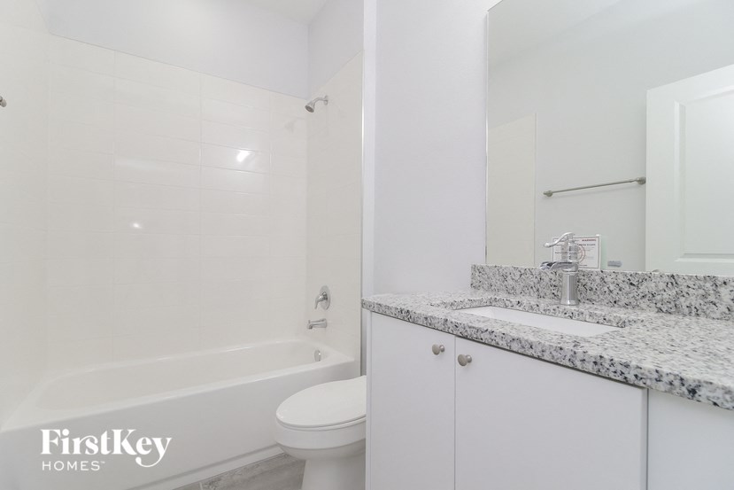 a bathroom with a sink and a toilet and a tub