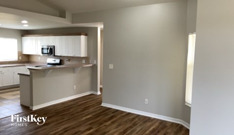 A kitchen with a counter and a microwave.