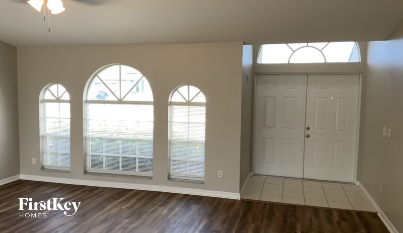 A room with a white door and a window with blinds.