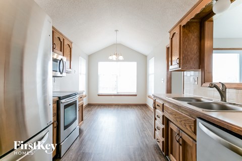 A kitchen with wooden cabinets and stainless steel appliances.