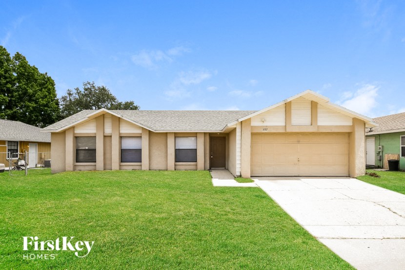 a home with a lawn and a driveway