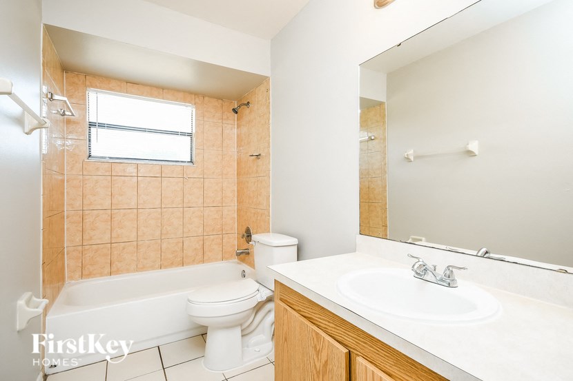 a bathroom with a sink toilet and a bath tub