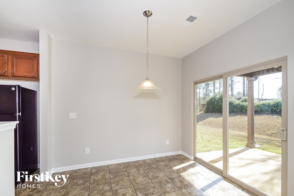 an empty kitchen and dining room with a sliding glass door to the yard