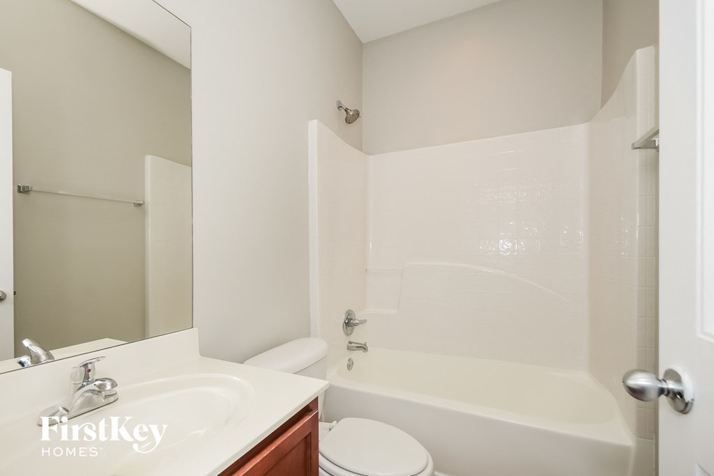 a bathroom with a sink and a toilet and a bath tub