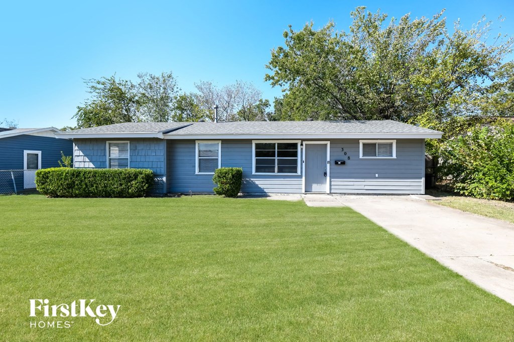 a blue house with a lawn in front of it