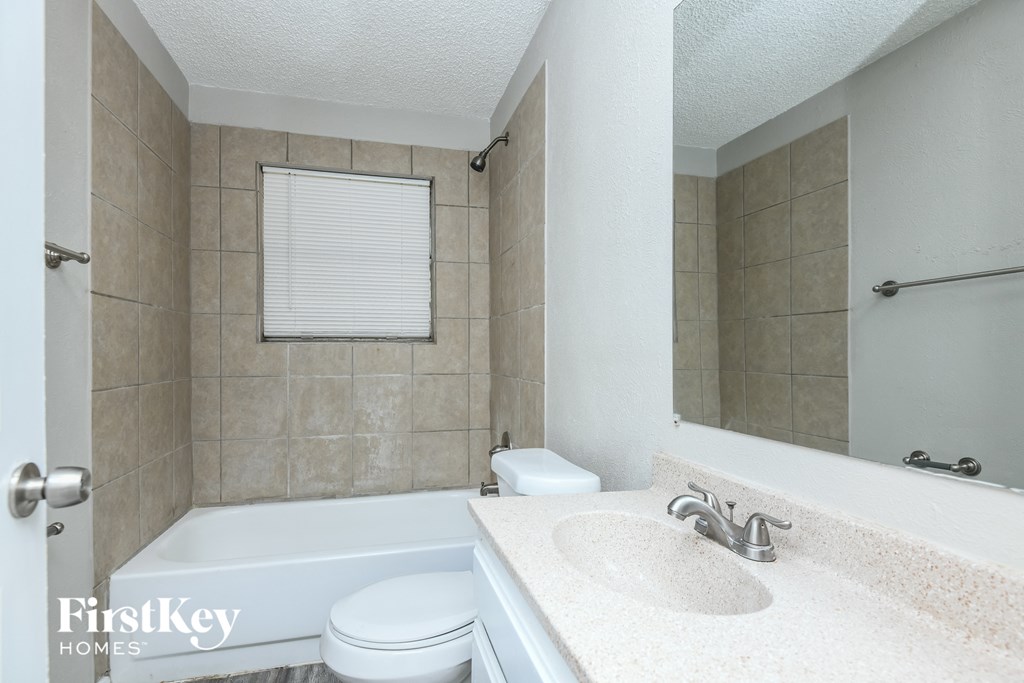 a bathroom with a sink and a tub and a toilet