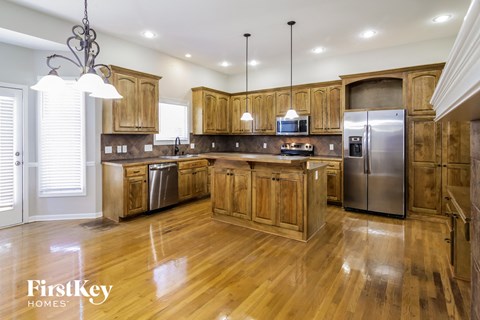 A kitchen with wooden cabinets and a center island.