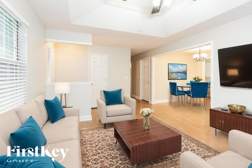 A living room with a couch, chairs, and a coffee table.