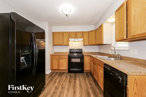 a kitchen with black appliances and wooden cabinets