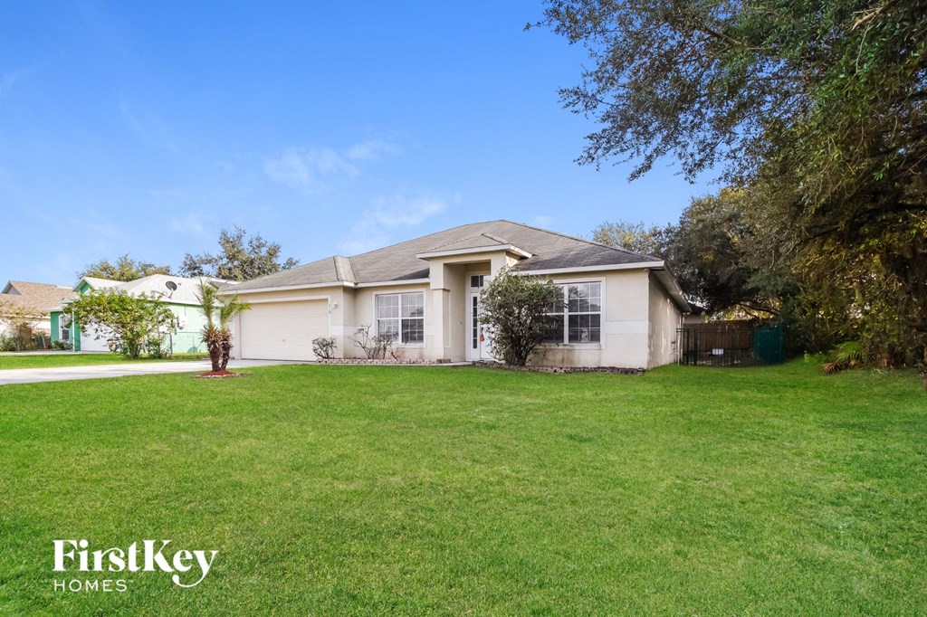 A house with a lawn in front of it.