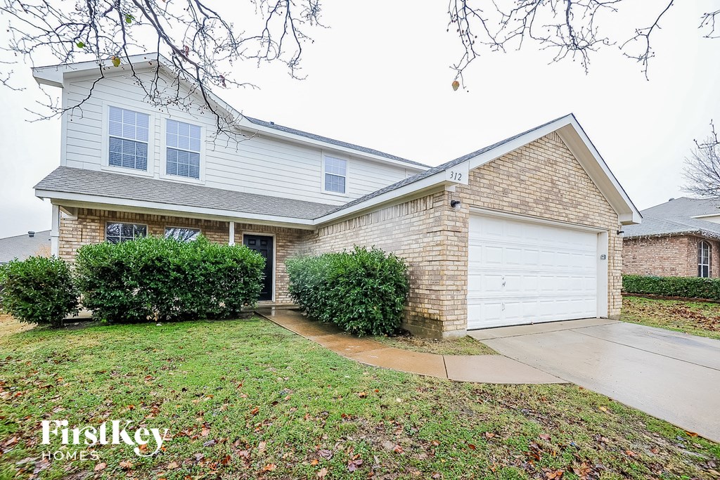 a home with a white garage door in front of it