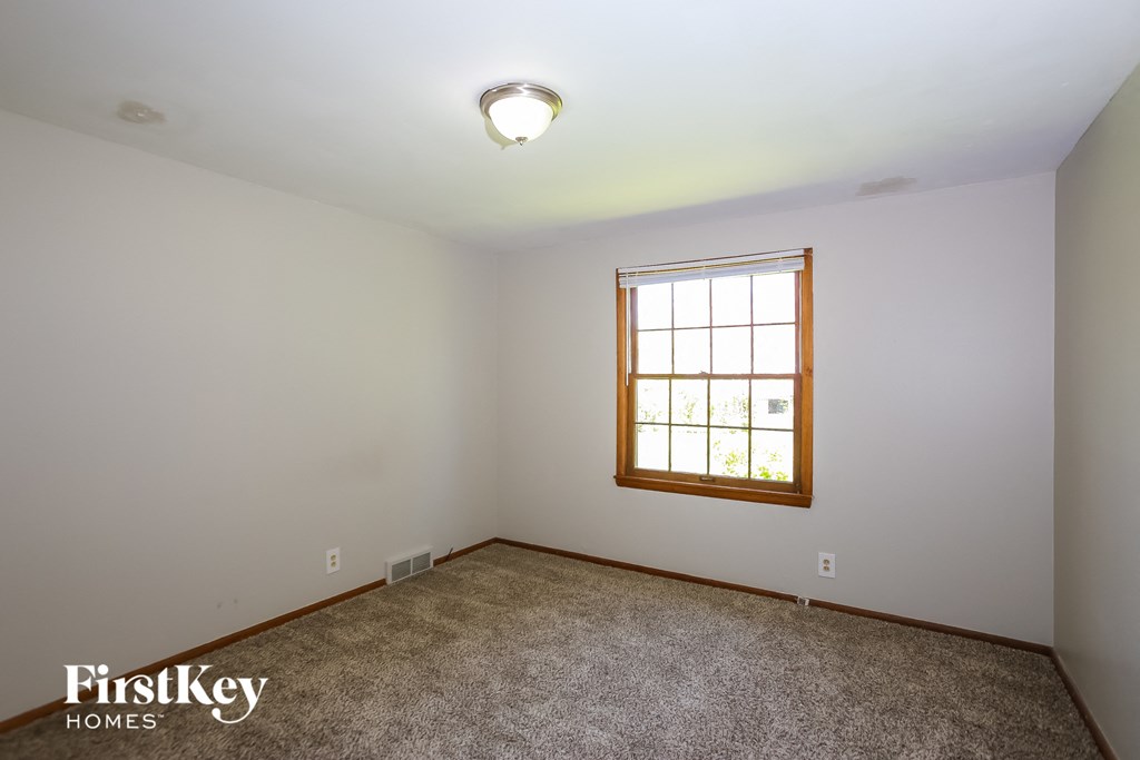the living room of an empty house with a window