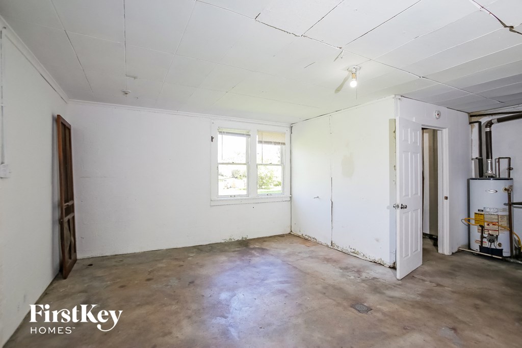 an empty room with white walls and a window
