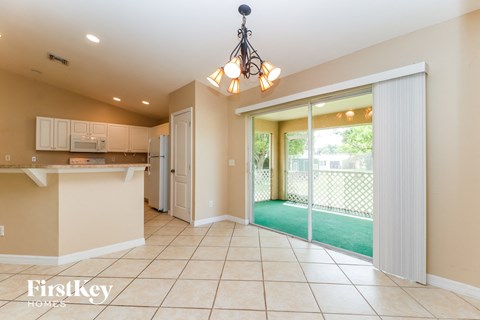 A kitchen with a counter and a chandelier.