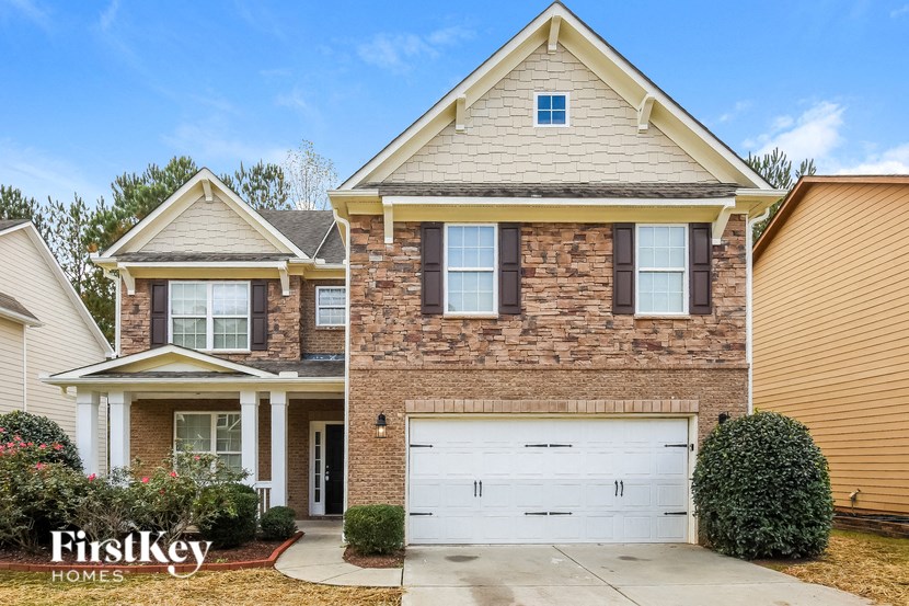 a brick house with a white garage door in front of it