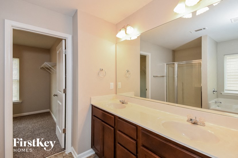 a bathroom with two sinks and a large mirror