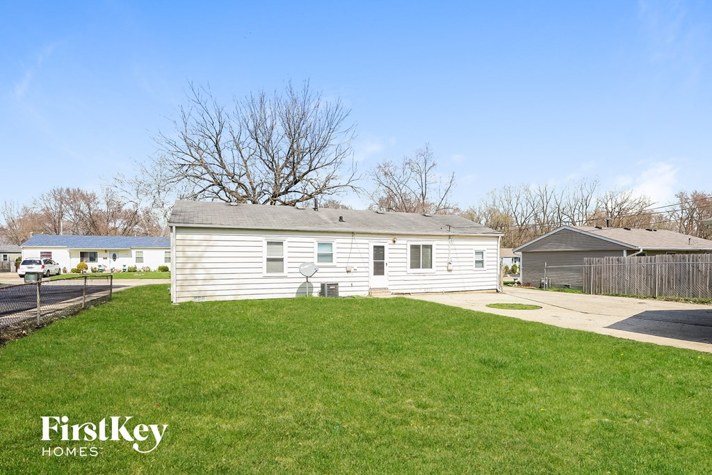 A house with a white siding and a grey roof is for sale by FirstKey Homes.