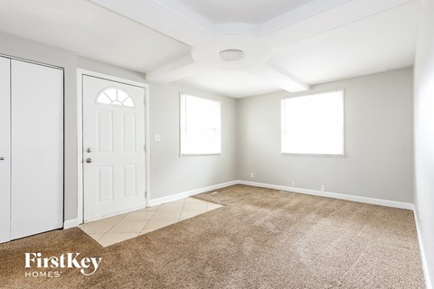 A room with a carpeted floor and a white ceiling.